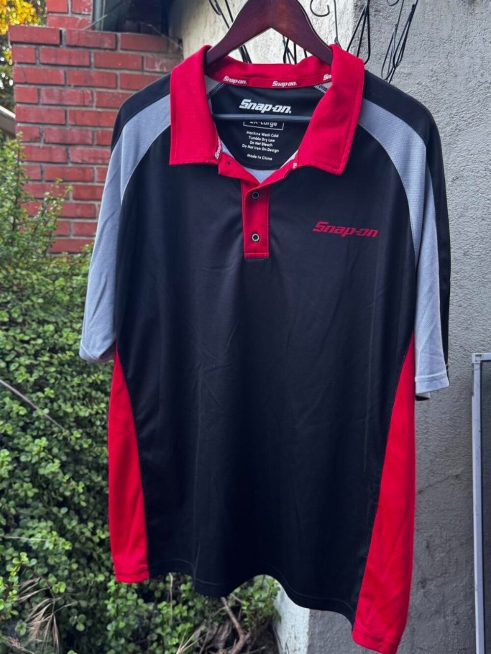 Snap-on black, red, and gray polo shirt